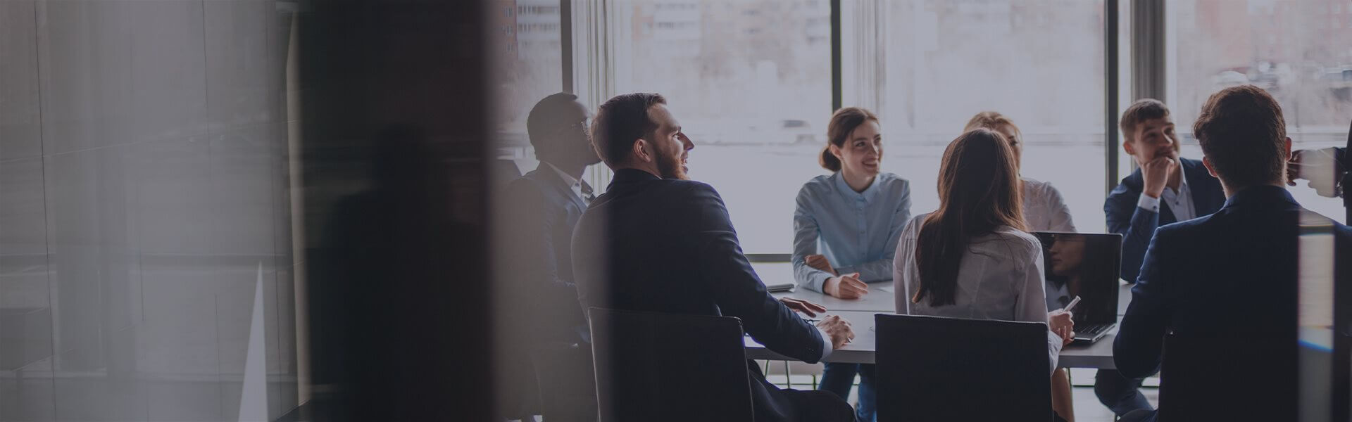 Image of people sat around a table in a meeting room